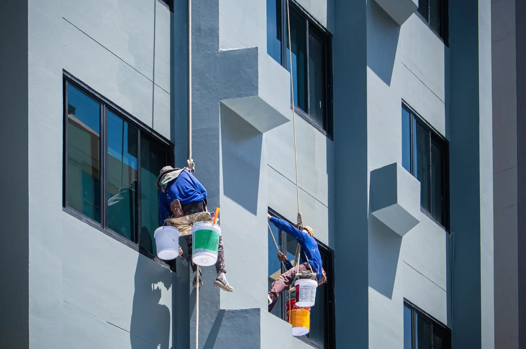 Two rope access window cleaners cleaning apartment windows on a Perth high rise